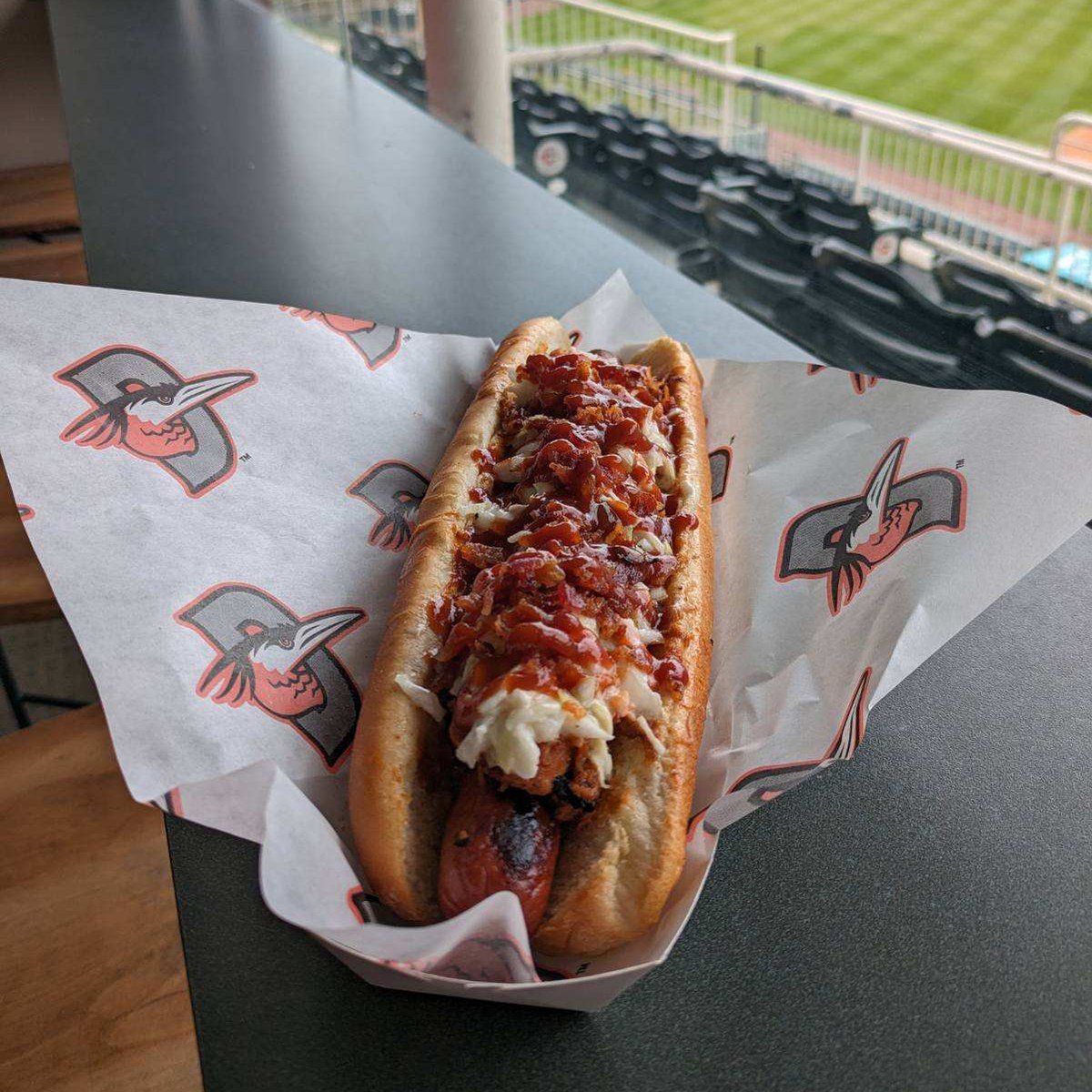 THIS WEEK, fans can enjoy the Shorebirds Salisbury Slaw Dog featuring a footlong hot dog topped with pulled chicken, coleslaw, bacon crumbles, and BBQ sauce! Get yours this homestand only at the Hickory Stand! 👇 Buy Tickets 👉 bit.ly/3HXnktz #FlyTogether | #Birdland
