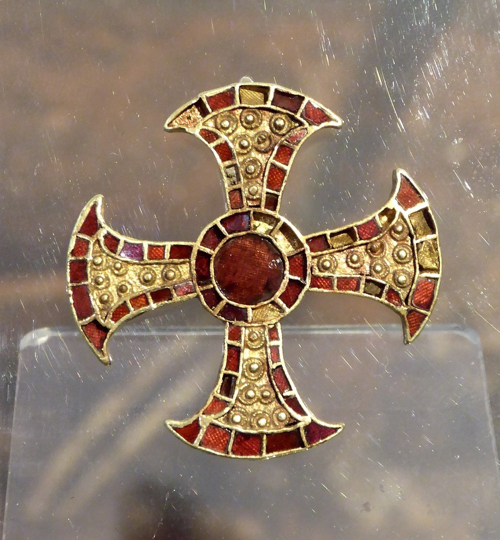 An ornate gold pectoral cross inlaid with garnets. The Trumpington bed burial is an early Anglo Saxon burial of a young woman, dating to the mid 7th c, that was excavated in Trumpington, Cambridgeshire, in 2011. Museum of Archaeology and Anthropology in Cambridge.