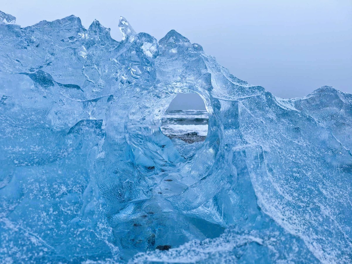 Large Iceberg with a window on the Diamond beach 😀❄💎 📸 by our amazing guide Alain Corbeau #iceland #iceberg #diamondbeach