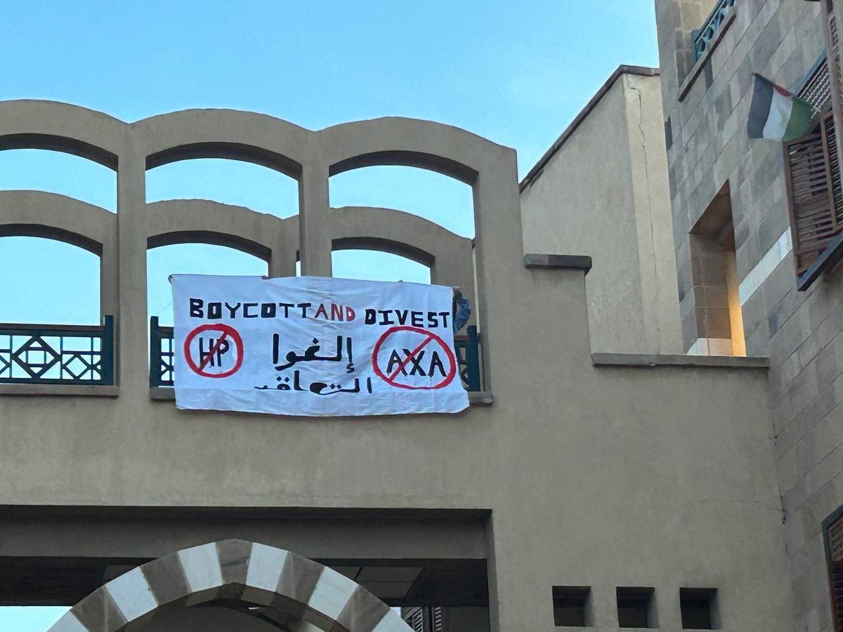 AUC security forcibly stopped students today at Tahrir from raising a banner reading ‘AUC Funds Genocide’, ‘Boycott HP & AXA’.