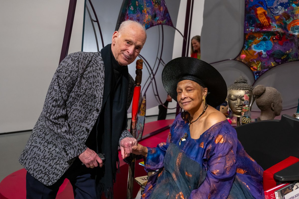artbma's tweet photo. Happy Birthday, John Waters! 🦩🎉 

We’re celebrating with this image of the Baltimore icon standing next to another local legend, Joyce J. Scott, taken at the opening of the artist’s 50-year career retrospective, Joyce J. Scott: Walk a Mile in My Dreams. https://t.co/dSeGlH883b