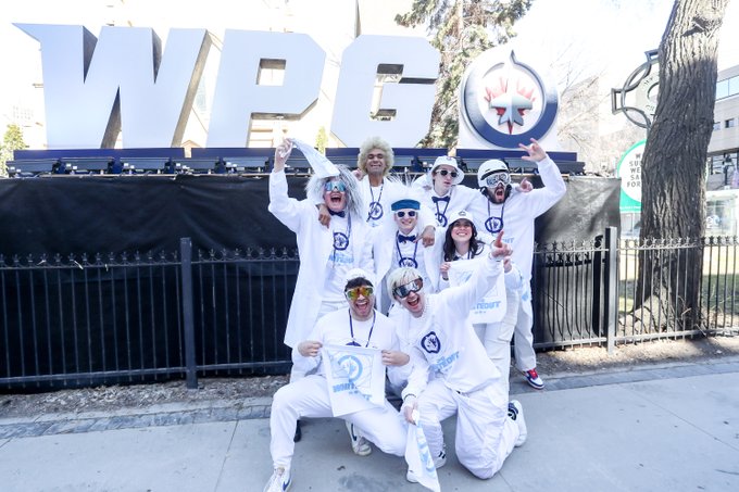 A group of Winnipeg Jets fans dressed in white. 