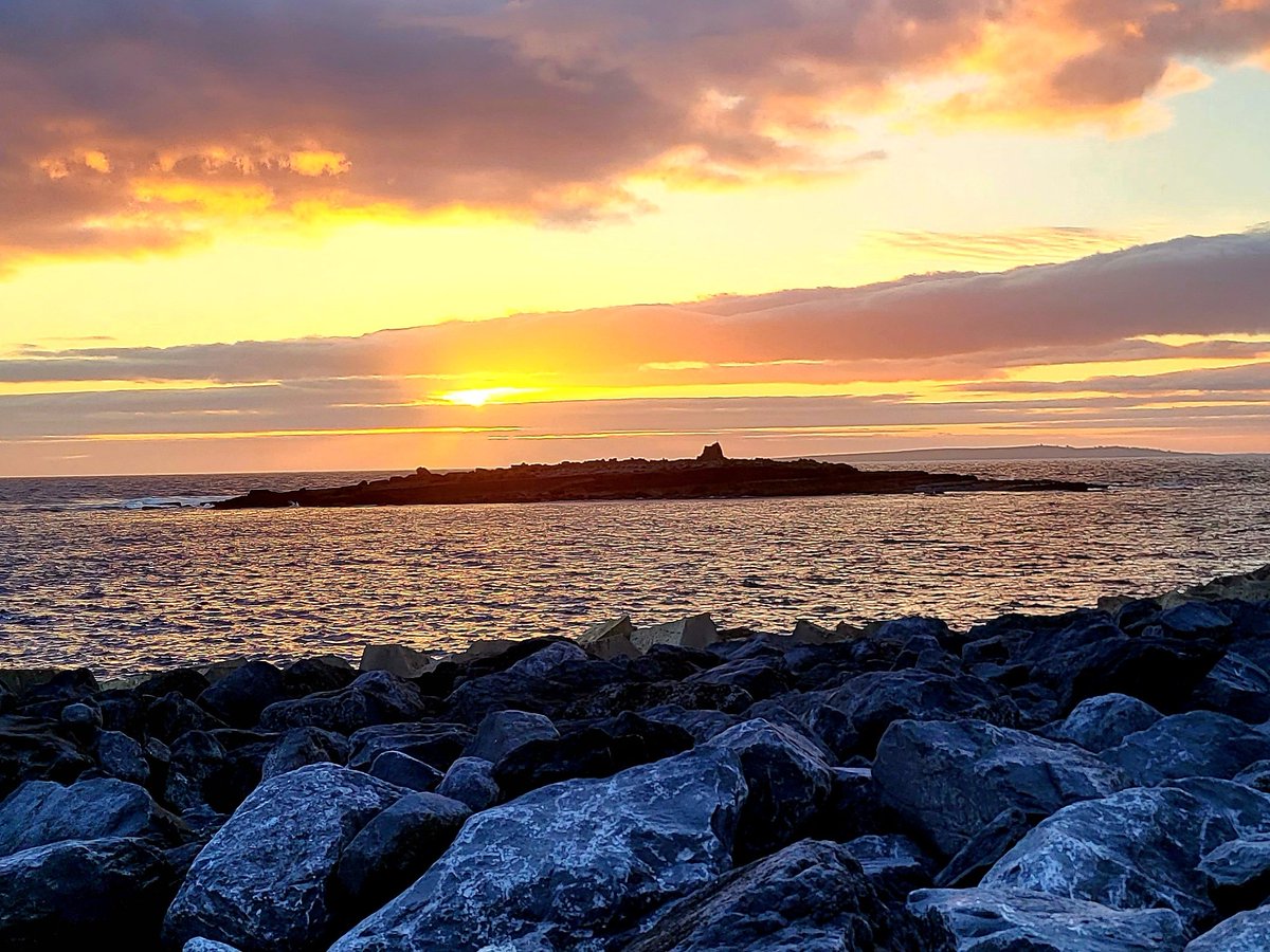 Evening sun dropping into the Atlantic behind Crab Island, Doolin, County Clare, Ireland.