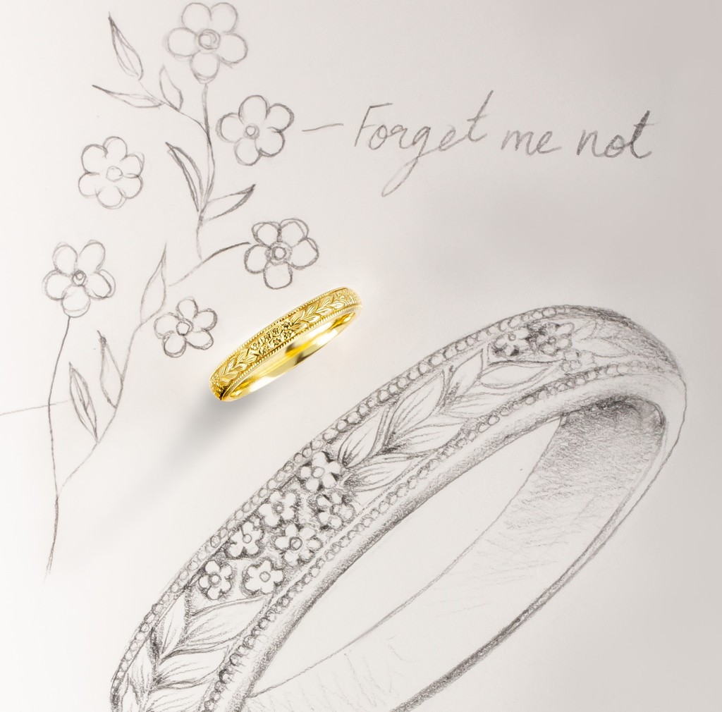 The forget-me-not flowers and leaves engraved in this unique wedding symbolises true love. Millegrain edged in the traditional vintage style, this 3.5mm court shape band in 18ct yellow gold is the perfect expression of your love story.