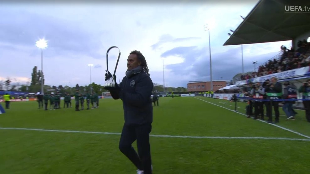foet247europa's tweet photo. Christian Karembeu brings the UEFA Youth League trophy out to the presentation. #UYL #OLYMIL https://t.co/cIt20UaBbF