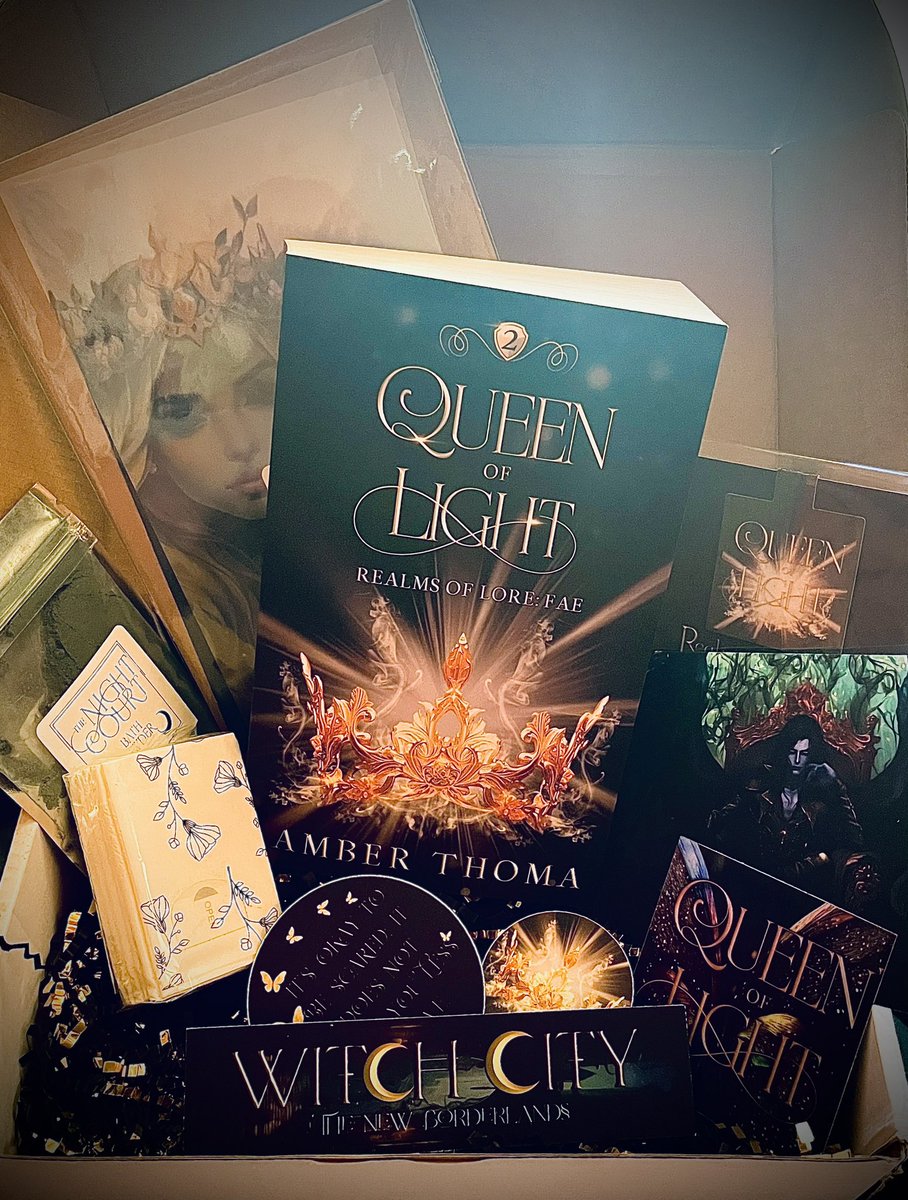 I’ve been in my writing cave working on my first adult romantasy but had to come out to open this STUNNING pr box! Queen of Light by the incredible Amber Thoma releases tomorrow 🖤 Now back to the cave! #writingcommunity #readingcommunity