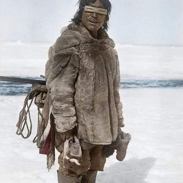 A Caribou Inuk from Arviat wearing an Ilgaak (snow goggles traditionally made of wood, bone, walrus ivory, caribou antler). Northwest Territories, Canada. 1921 Colorized by Ross' Restorations.