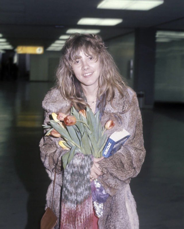 Stevie Nicks holding a copy of 'Dune' in 1977