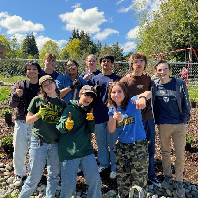 High school students pose for a group photo at Geneva Elementary