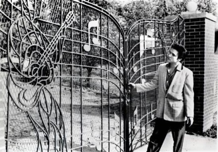 Elvis admiring the Gates at Graceland. The gates were installed Aprill 22, 1957