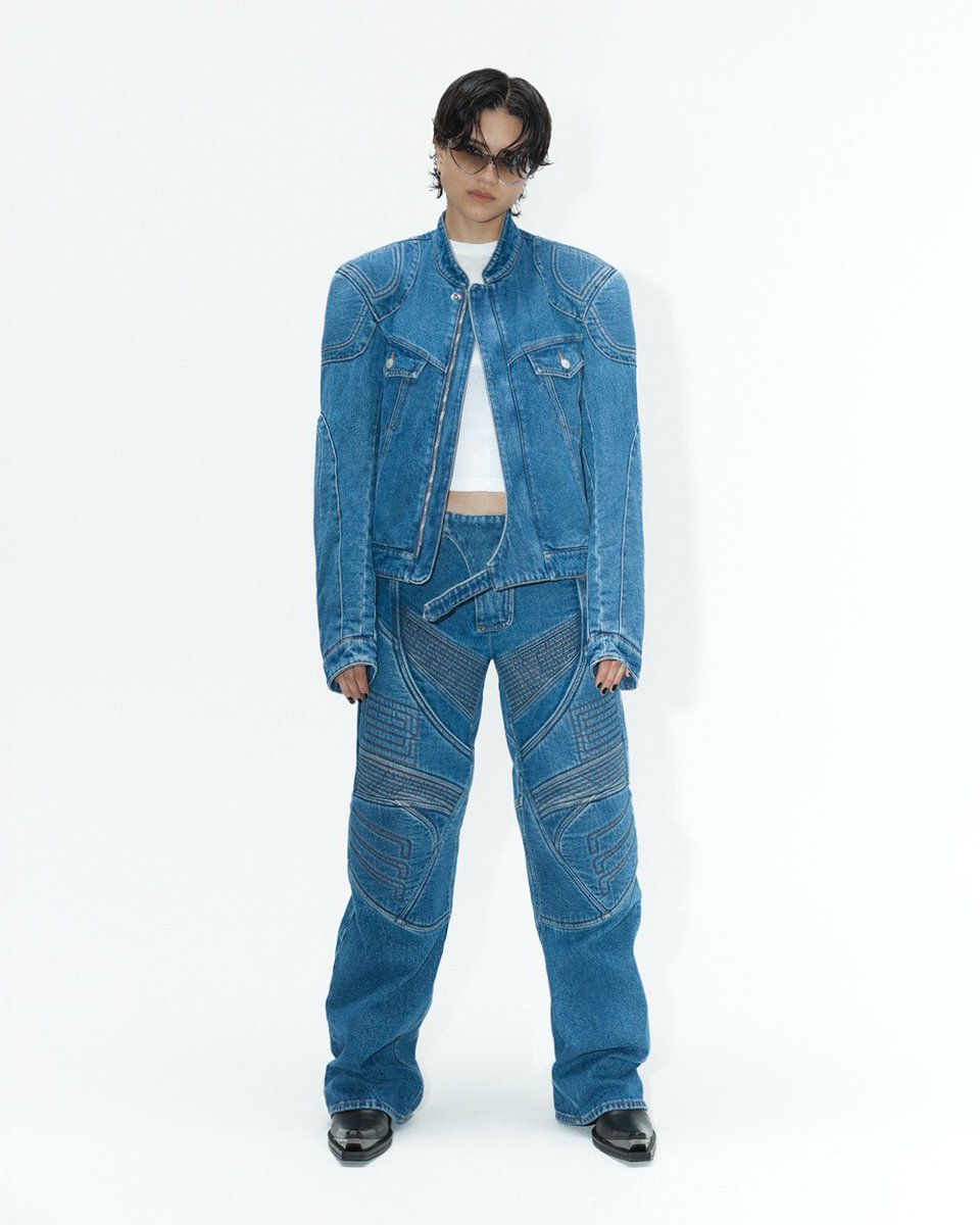 Biker archetypes reimagined in washed blue denim. Sasha Calle wearing new season denim, with transparent metal frame eyewear. Discover more in-store and at bit.ly/3y8wBxv.   Photographer: Thomas Lohr Stylist: Léopold Duchemin Talent Stylist: Chloe and Chenelle Delgadillo