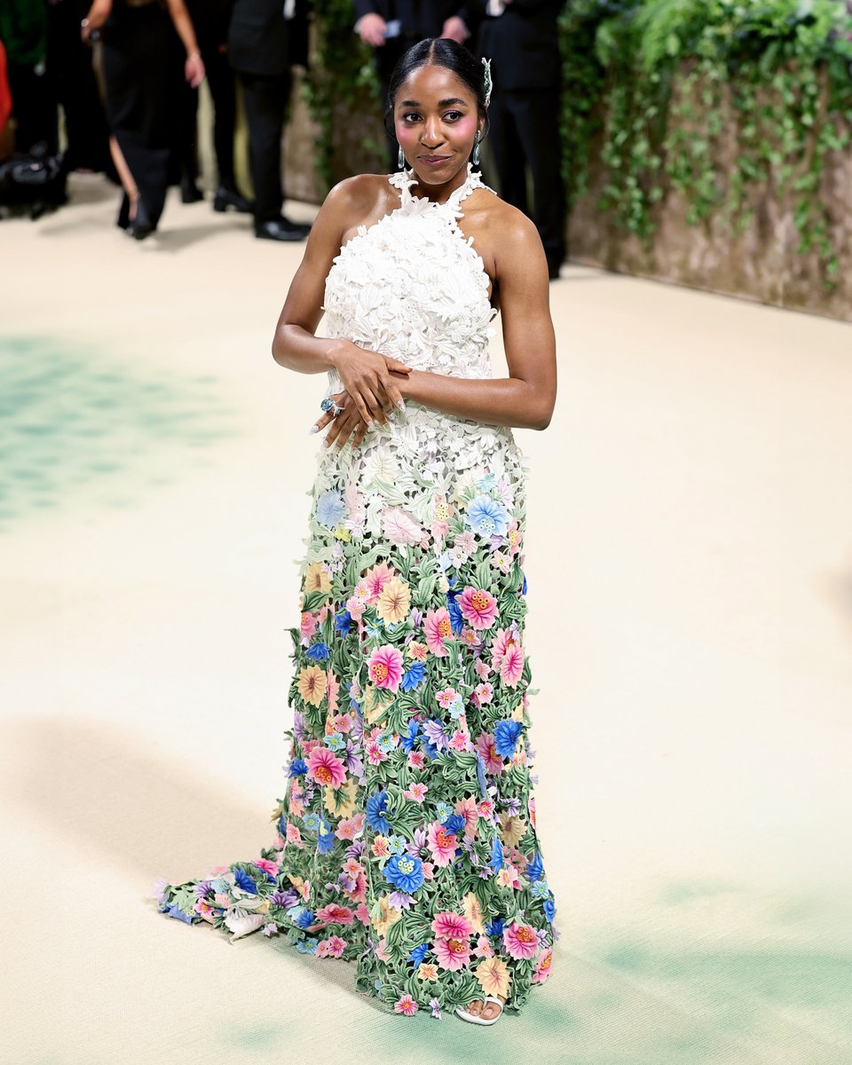 Ayo Edebiri in bespoke LOEWE at the Met Gala 2024. Crafted in intricate guipure lace, the halter-neck column dress is first hand-painted and then hand-embroidered to create an optical illusion of 3D flowers. Styling Danielle Goldberg #LOEWE #MetGala