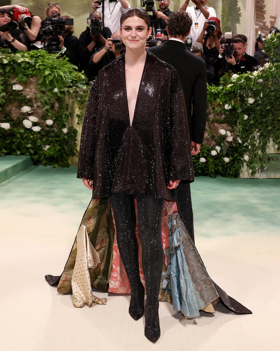Alison Oliver in bespoke LOEWE at the Met Gala 2024. A trapeze coat and train in brown silk duchess satin is embroidered with all-over crystals, while garments and fabrics from the 16th century are repurposed to create a patchworked lining. Styling Aimee Croysdill #LOEWE