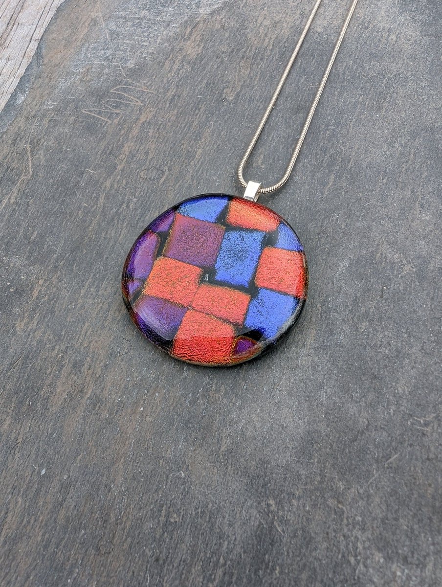 Beautiful new circular patchwork dichroic glass necklace. Beautiful shimmering blues, purples and red within this unique pendant. #handmade #jewellery #etsy #giftideas #shopindie buff.ly/3wfEmkF