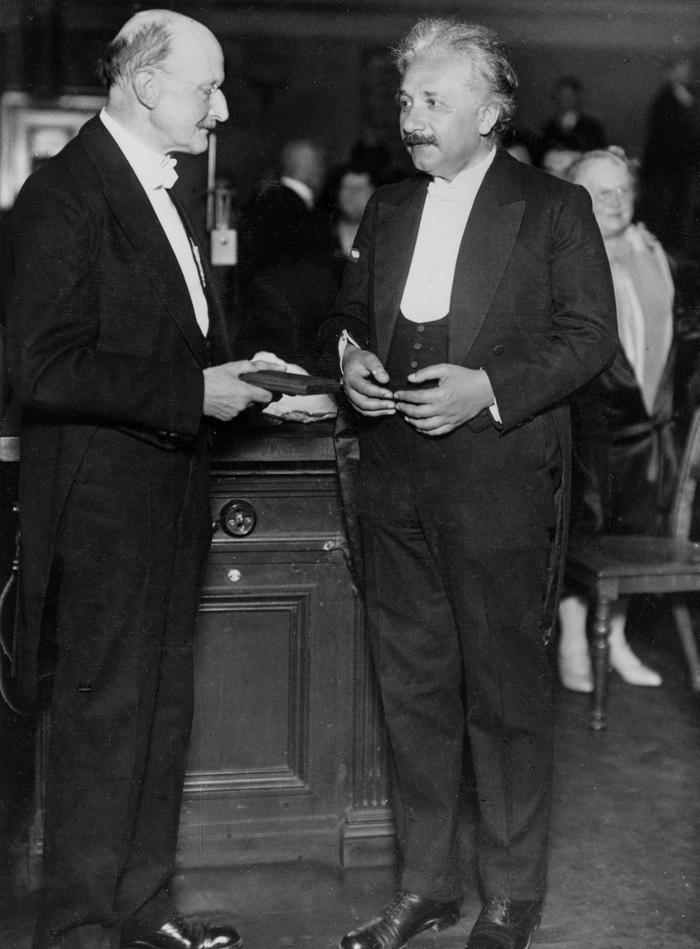 Albert Einstein receiving an award from Max Planck with his name on it, 1929.