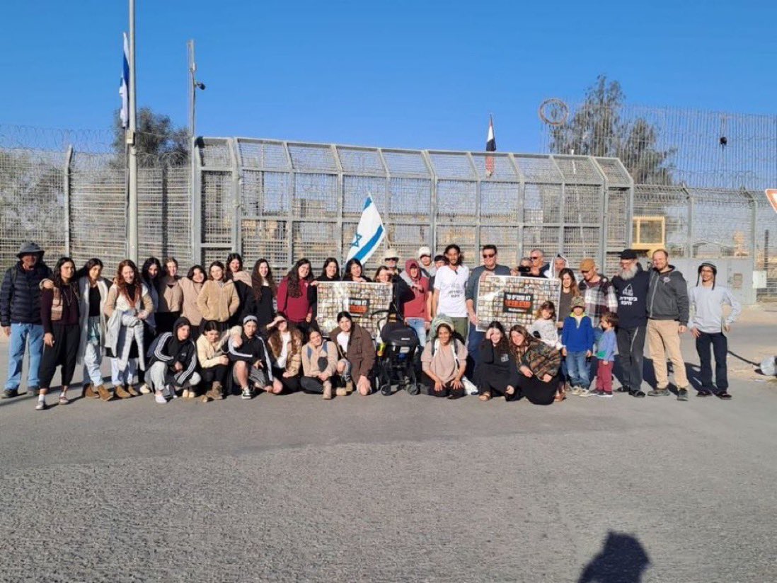 Israeli families at the Nitzana border crossing. They were there to block aid trucks entering Gaza Those aid trucks would carry food to starving children. These people have taken a picture of themselves for posterity. They are proud of their genocide.