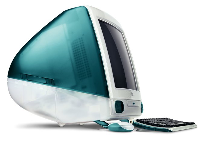 a "Bondi Blue" iMac G3 with a keyboard and mouse.