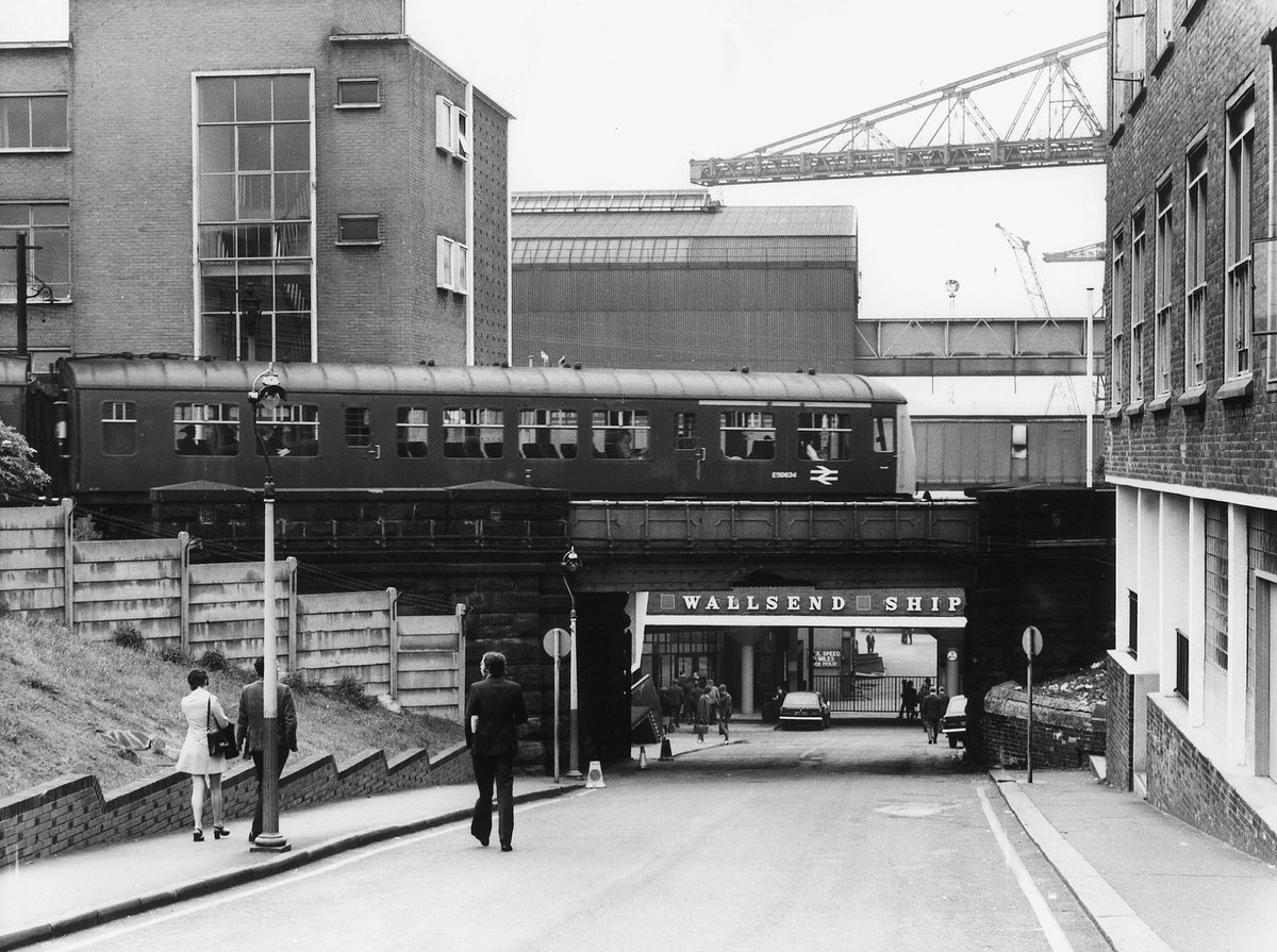A train heading towards #Newcastle on the Tyne Riverside Branch passes the entrance to Swan Hunter's Shipyard, #Wallsend in the early 1970s.