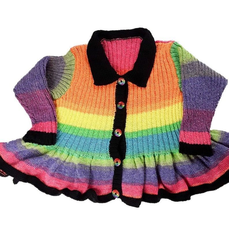 Embrace the rainbow with this sparkly hand knitted peplum cardigan for girls! Sized for a 30 inch chest. Crafted by #Knittingtopia, available now on #Etsy! etsy.me/3ZdVGjQ #handmade #childrensknitwear #handknits #rainbow #MHHSBD #craftbizparty #uksmallbiz