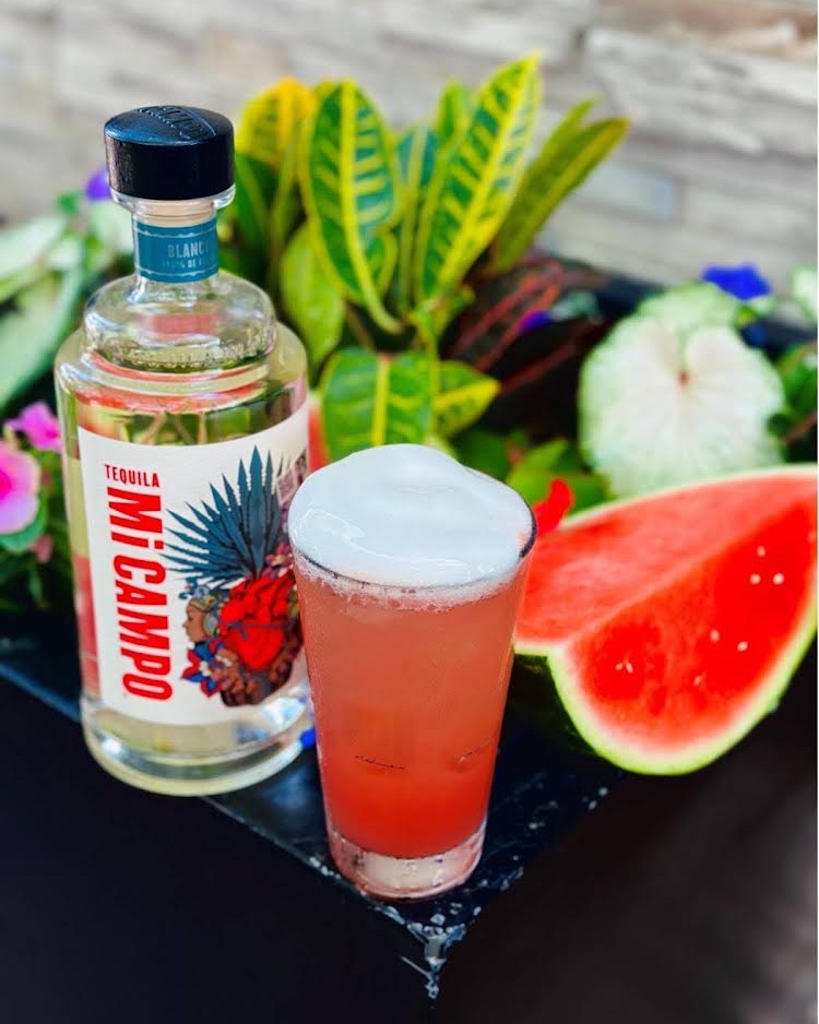 🍉🍹🌿 This Cinco de Mayo, indulge in a refreshing Watermelon Margarita from Mi Dia! This margarita of the month is infused with Mi Campo Tequila Silver, complemented by basil agave, St Germain, and a hint of lemon, all topped with a delightful basil mint espuma.