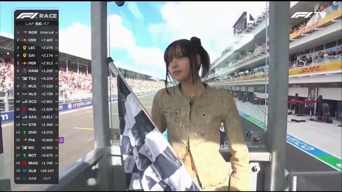 BLACKPINK's Lisa with the chequered flag at the 2024 F1 Miami Grand Prix.