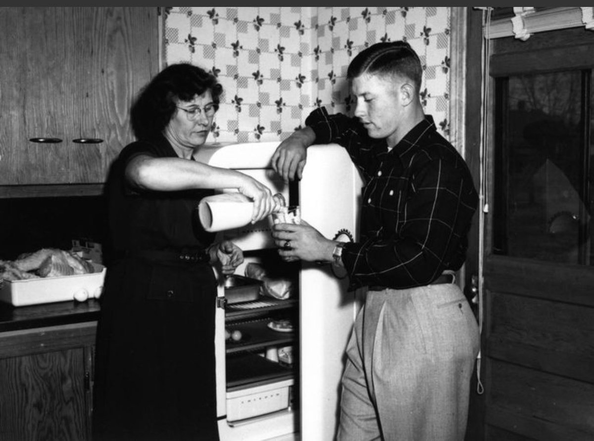 Mickey Mantle getting some milk from his mother