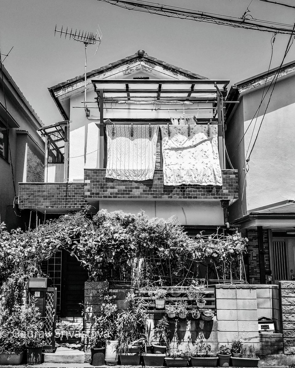 A traditional Japanese house with futons hung outside the balcony, exposed to the sunlight on a brilliantly sunny day. #streetphotography #blackandwhite #tokyo #Japan