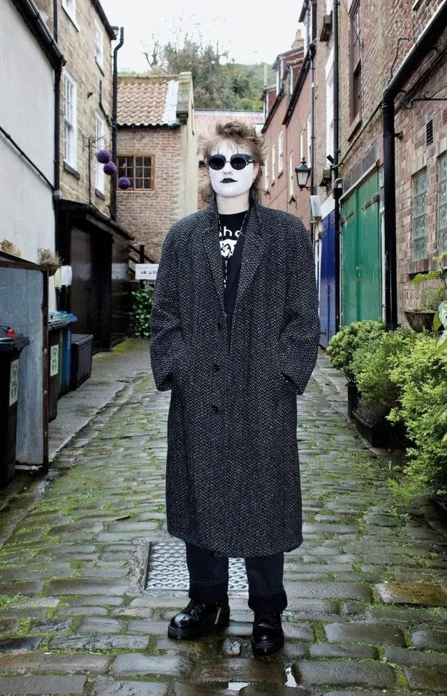 Goths: a modern tribe of England

I can see some of the earlier influences that gave rise to the Goth subculture coming through here. The long tweedy coat of the New Wave; the 'big hair' of the New Romantic and the boots of the Punks.
This is Jayden