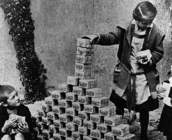 German kids playing with stacks of hyper-inflated currency during the Weimar Republic. (The highest value banknote issued by the Weimar government's Reichsbank had a face value of 100 trillion Mark. By 1923, the banknotes had lost so much value that they were used as wallpaper)