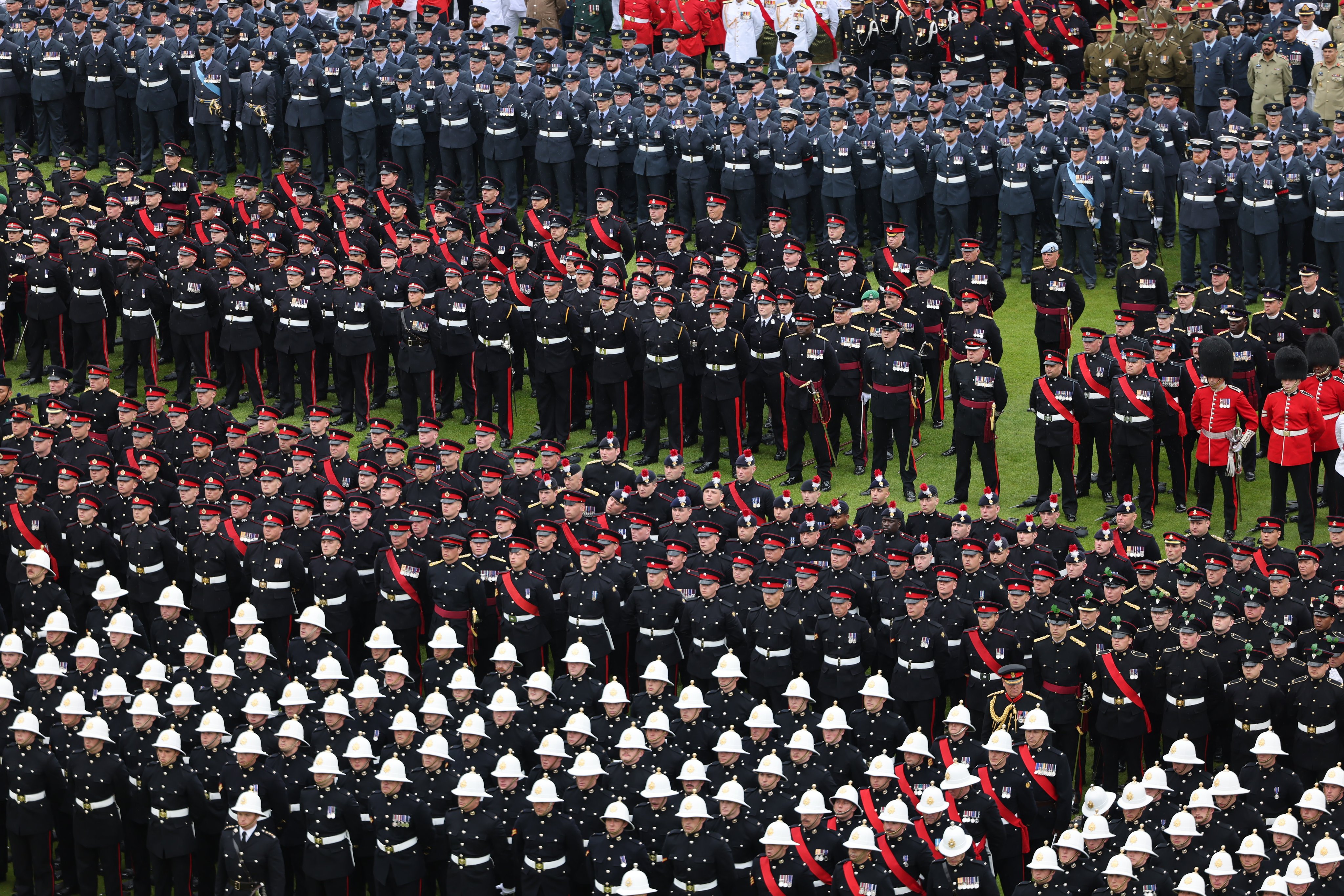 Rows of uniformed members of the Armed Forces assembled in the garden of Buckingham Palace on the day of the Coronation.