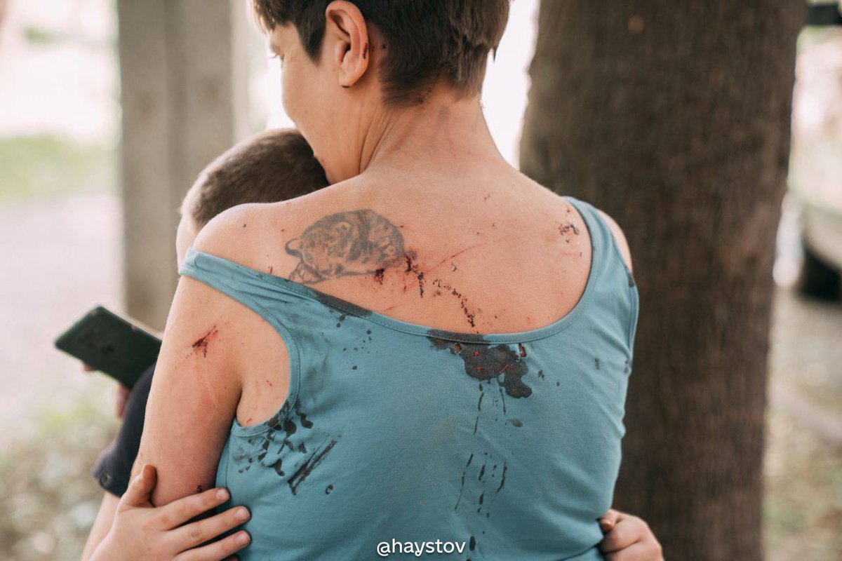 A devastating photo of a mother hugging her son after surviving russian bombing in Kharkiv.