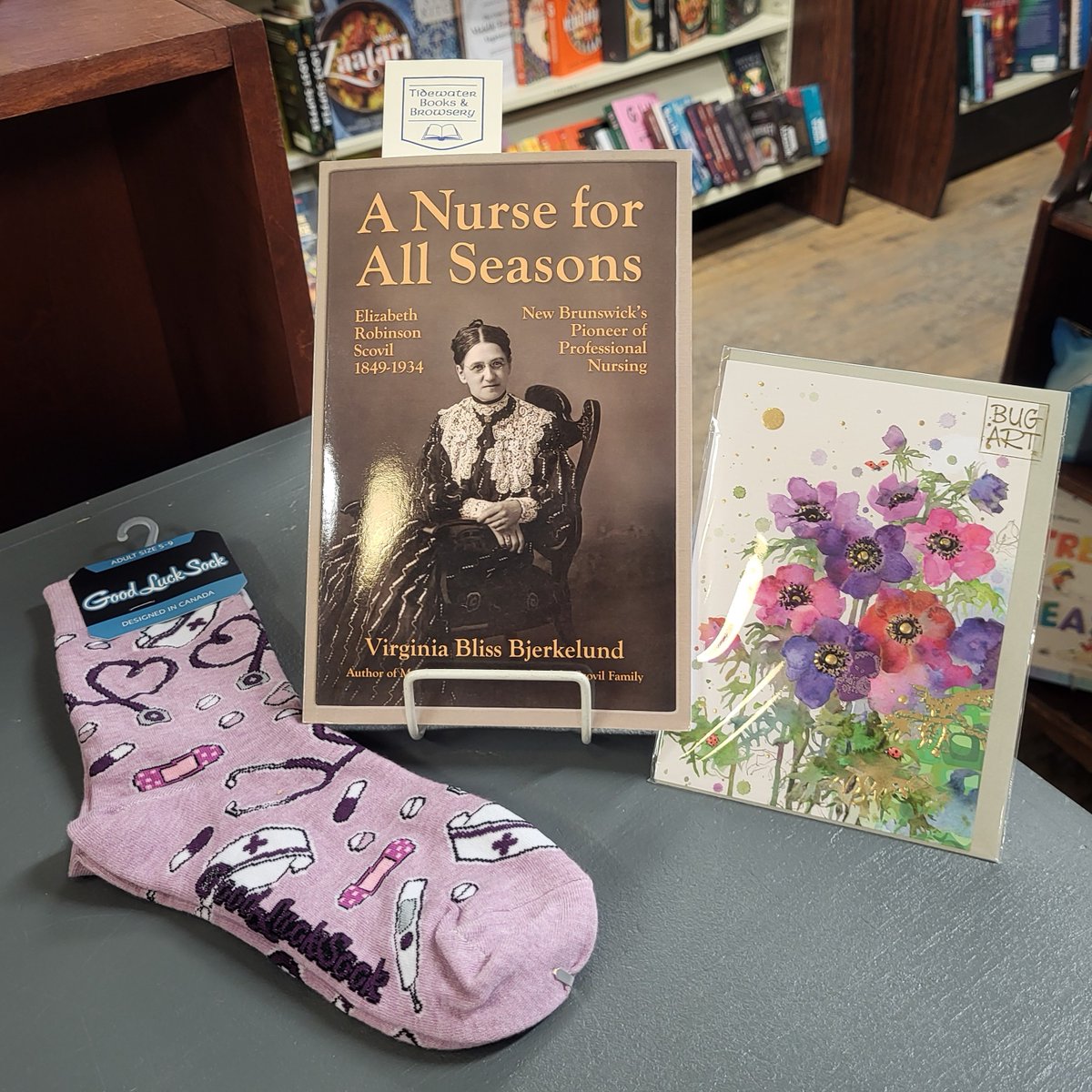 Today's #MaritmeMonday & #NurseDay Featured #NBLit in-store is A Nurse for All Seasons by #NSWriter Virginia Bliss Bjerkelund. Pictured with fun #GoodLuckSocks & a colourful #BugArt card. Show your favourite health care worker some love today with books & beauty!💕🇨🇦📚🧑‍⚕️⚕️❤️‍🩹🧦