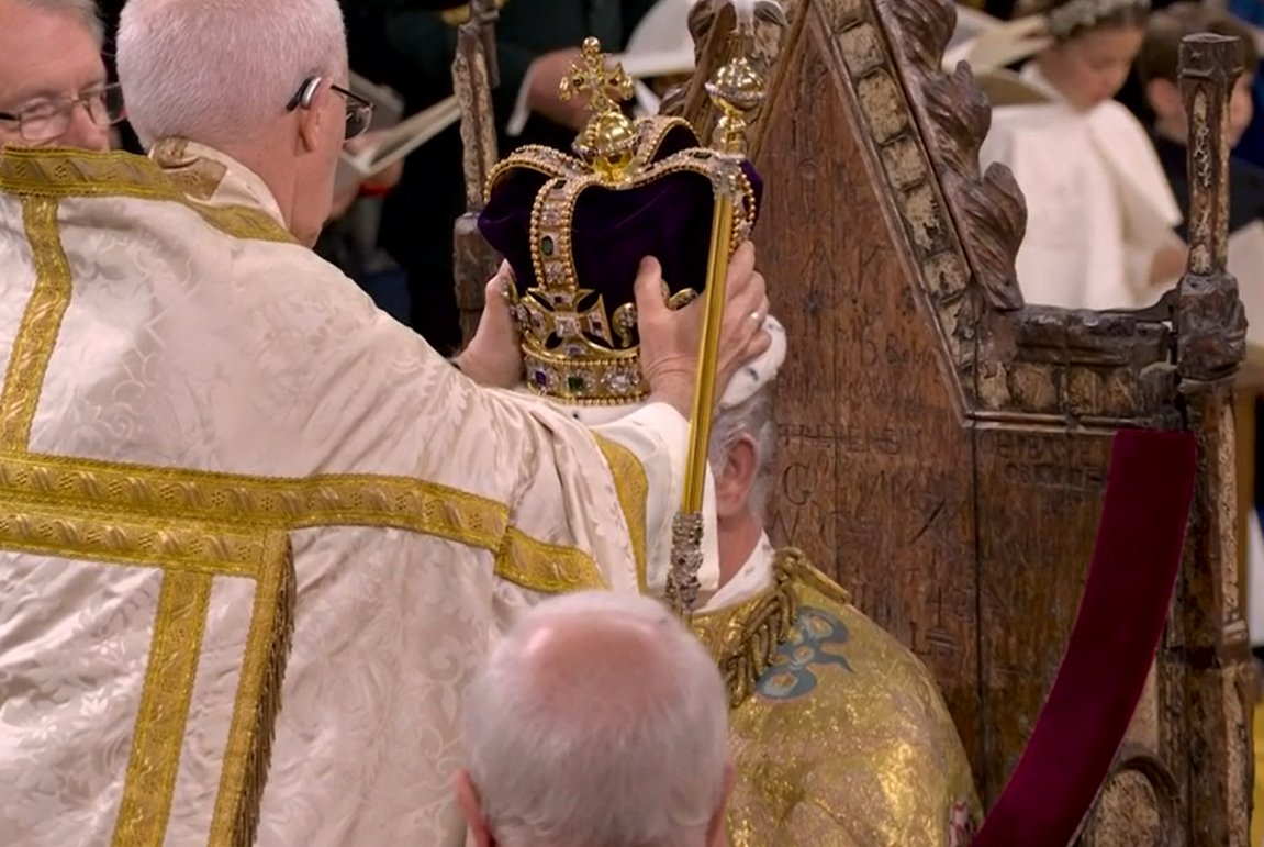 The moment of Coronation. King Charles III, crowned with St. Edward's Crown, at Westminster Abbey. The Archbishop of Canterbury led the cries of 'God Save the King'