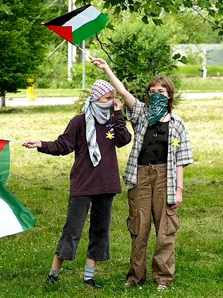 Disgraceful Palestine activists stand outside AUSCHWITZ wearing Yellow STAR OF DAVID badges. The activists taunted Jewish Holocaust survivors on Holocaust Remembrance Day and heckled them as they held a ‘March for Life’ to remember the 6 million Jews who lost their lives.