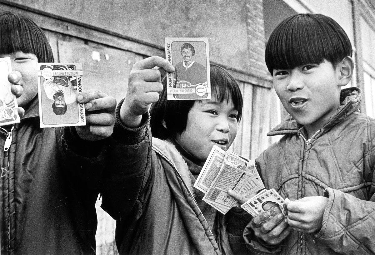 Young boys in Steveston Village in Richmond, BC holding up hockey cards in 1973