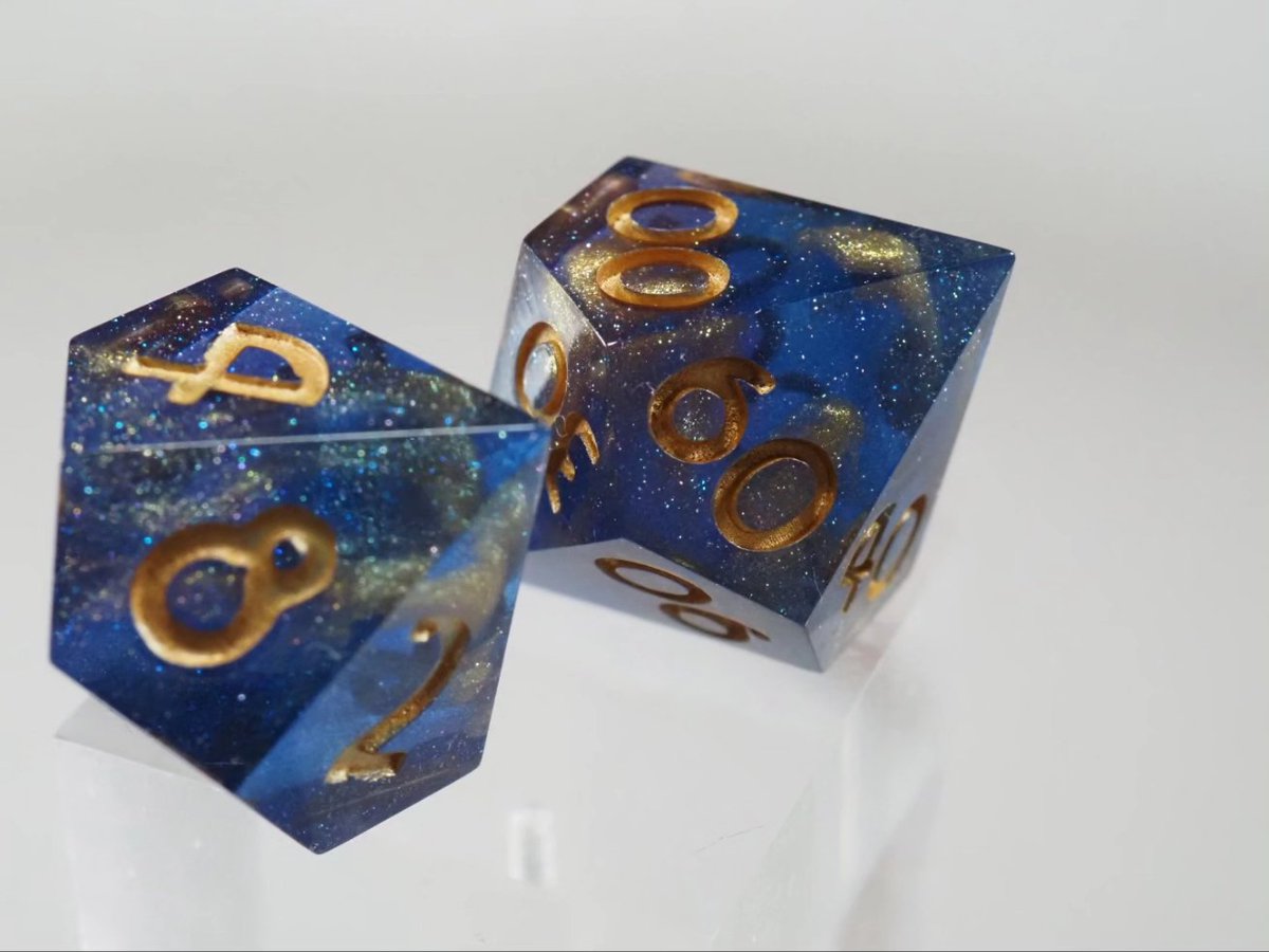 These dice remind me so much of golden galaxies inside a vast sea of stars. These were a recent commission and I really like how they turned out, what do you think? (Advertisement) #dnd #handmadedice #dnd5e #epoxy #resin #rpg #ttrpg #diceset #würfel #d20 #dice #pnp #pnpde