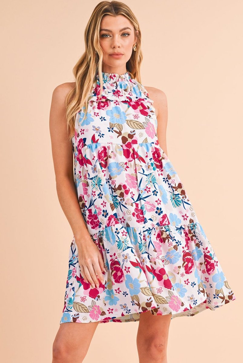 Our White Frill Mock Neck Sleeveless Tiered Floral Dress! Perfect for embracing the summer breeze with its breezy silhouette and delicate floral pattern. Shop now and bloom in style! #FloralDress #SummerFashion #TieredDress #MockNeck #SleevelessDress #Fashionista