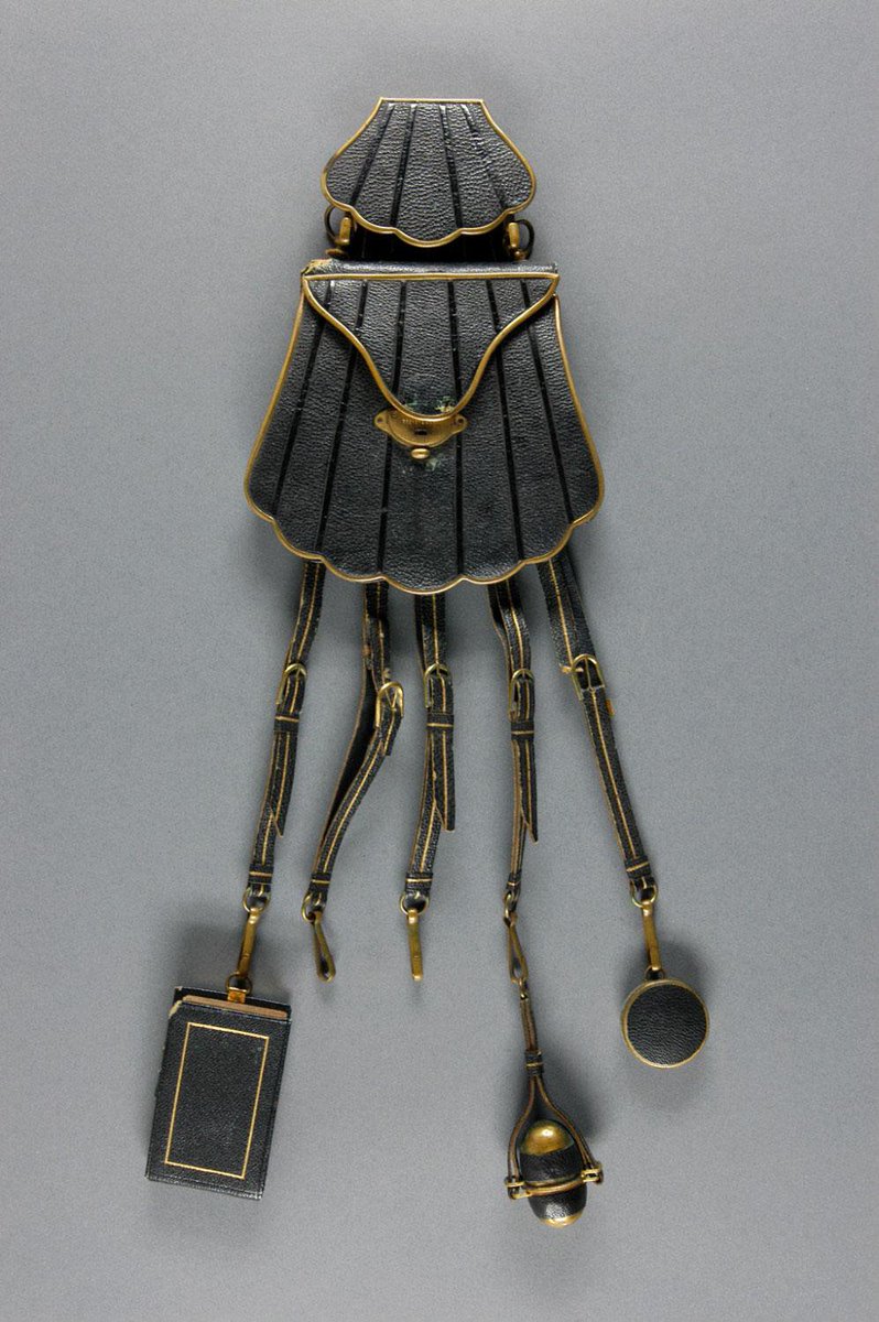 Chatelaine with paper pad, sewing egg, and pincushion, 1870. Leather, brass. France. Philadelphia Museum of Art.