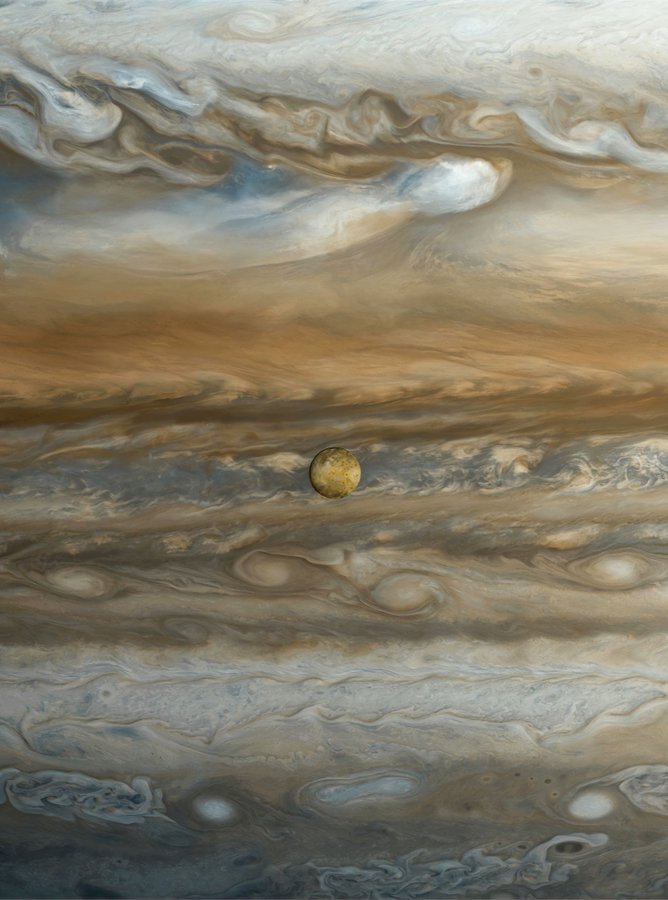 Jupiter's moon Io against the background of the gas giant's atmosphere. The photo was taken by the Voyager 1 spacecraft in 1979.