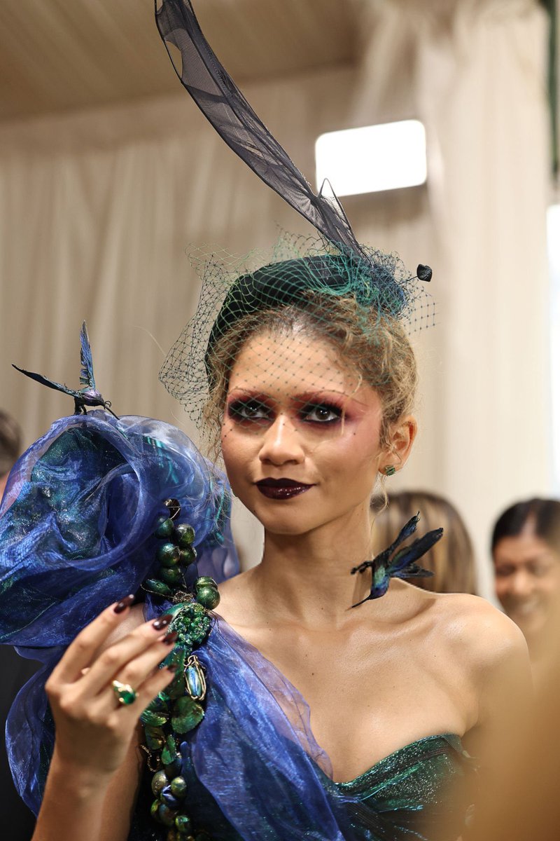 Understood the assignment. Zendaya is giving with her smokey red eyes, the florals and dark lip. #Zendaya #MetGala