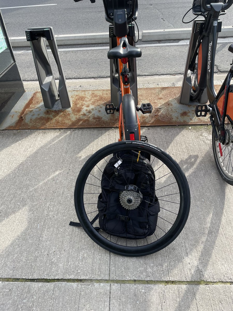 maclellanally's tweet photo. Still biking to run errands, even though my wheel was in the shop! Zipped over to my LBS to pick it up on a @BikeShareTO #ebike and carried it home using yoga mat straps on my backpack. Efficient, effective and eco-friendly! #biketo https://t.co/ZdadIBasRG