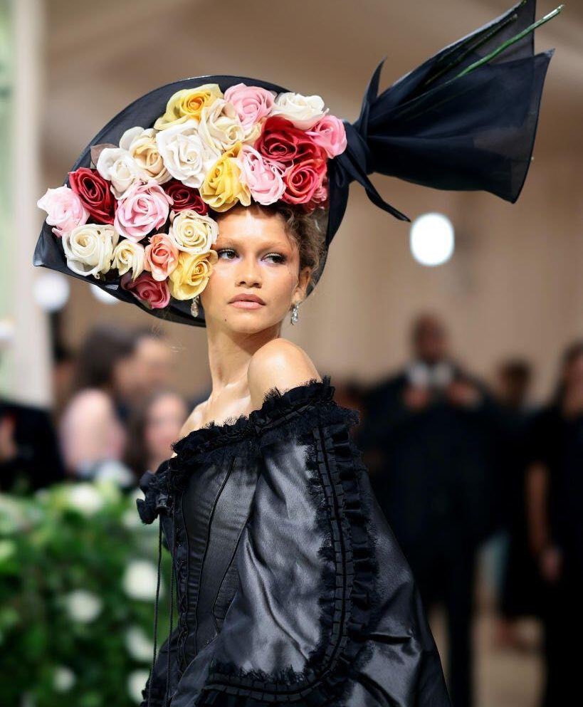 Zendaya is wearing Givenchy S/S 1996 Couture and the flower bouquet from the Alexander McQueen S/S 2007 collection by Philip Treacy