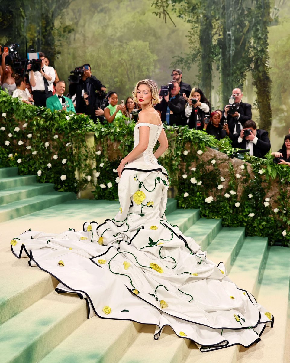 … gigi … gigi hadid wears a custom thom browne corset dress embroidered with over two million white micro bugle beads and a draped tailored jacket in white silk moire with black duchess satin tipping and rose appliques throughout with wingtip pumps in white and yellow pebble…