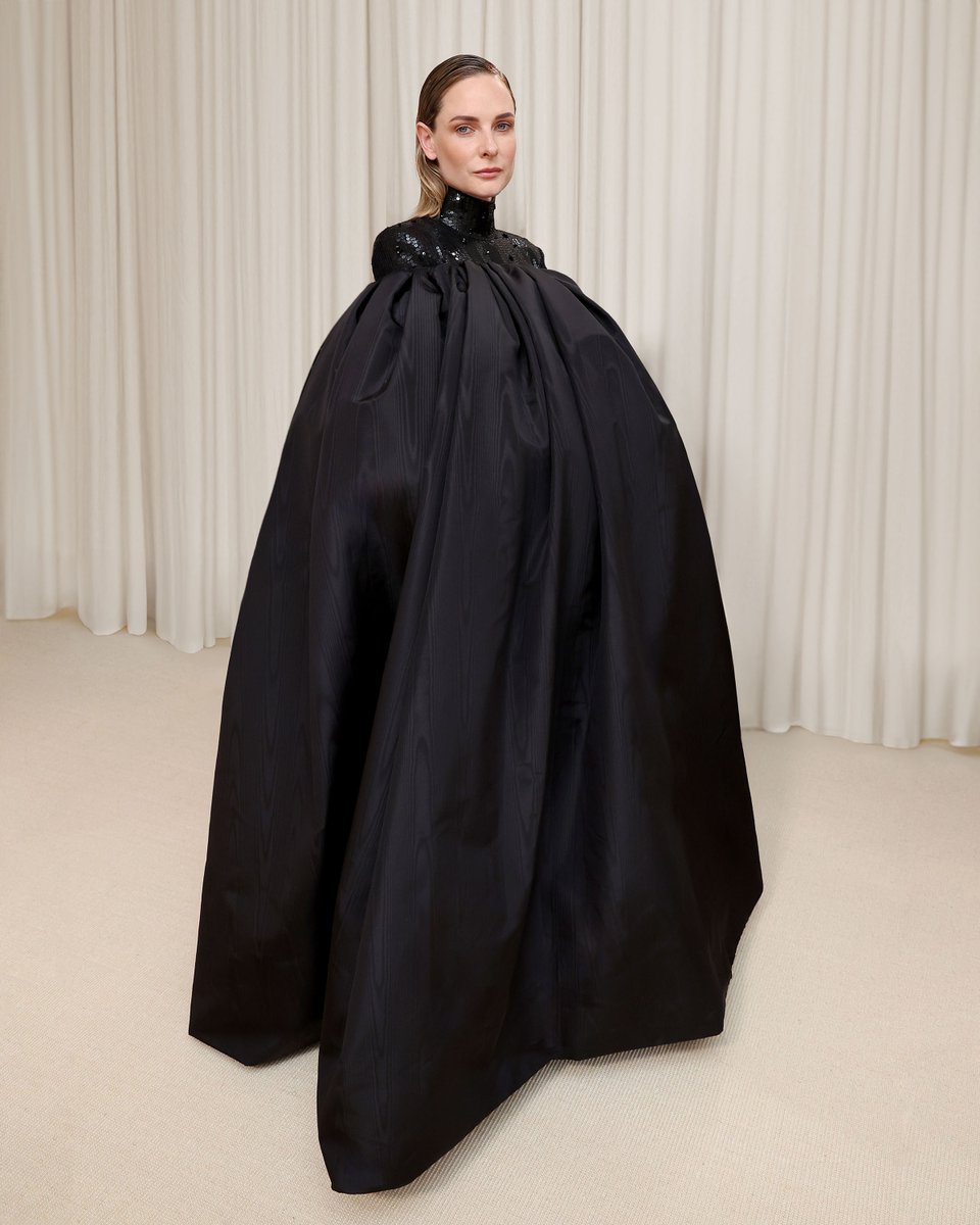 … rebecca … rebecca ferguson wears a custom thom browne gathered cape in black silk moire with blue moire lining and black raven appliques over a rep stripe high neck dress embroidered with black and white sequins, raffia, lurex, and sequin black ravens and 60,000 blue and…