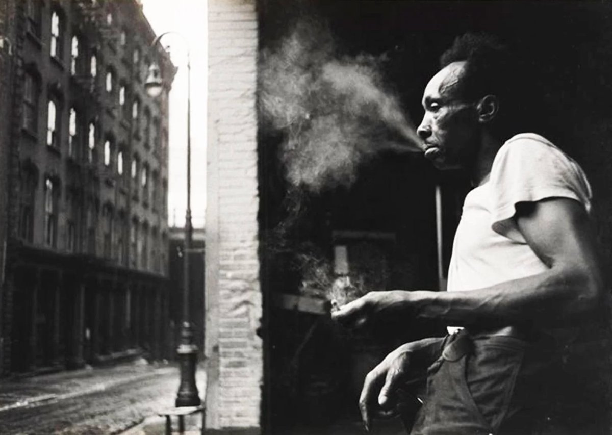 Erich Hartmann Man smoking under the Brooklyn Bridge 1955