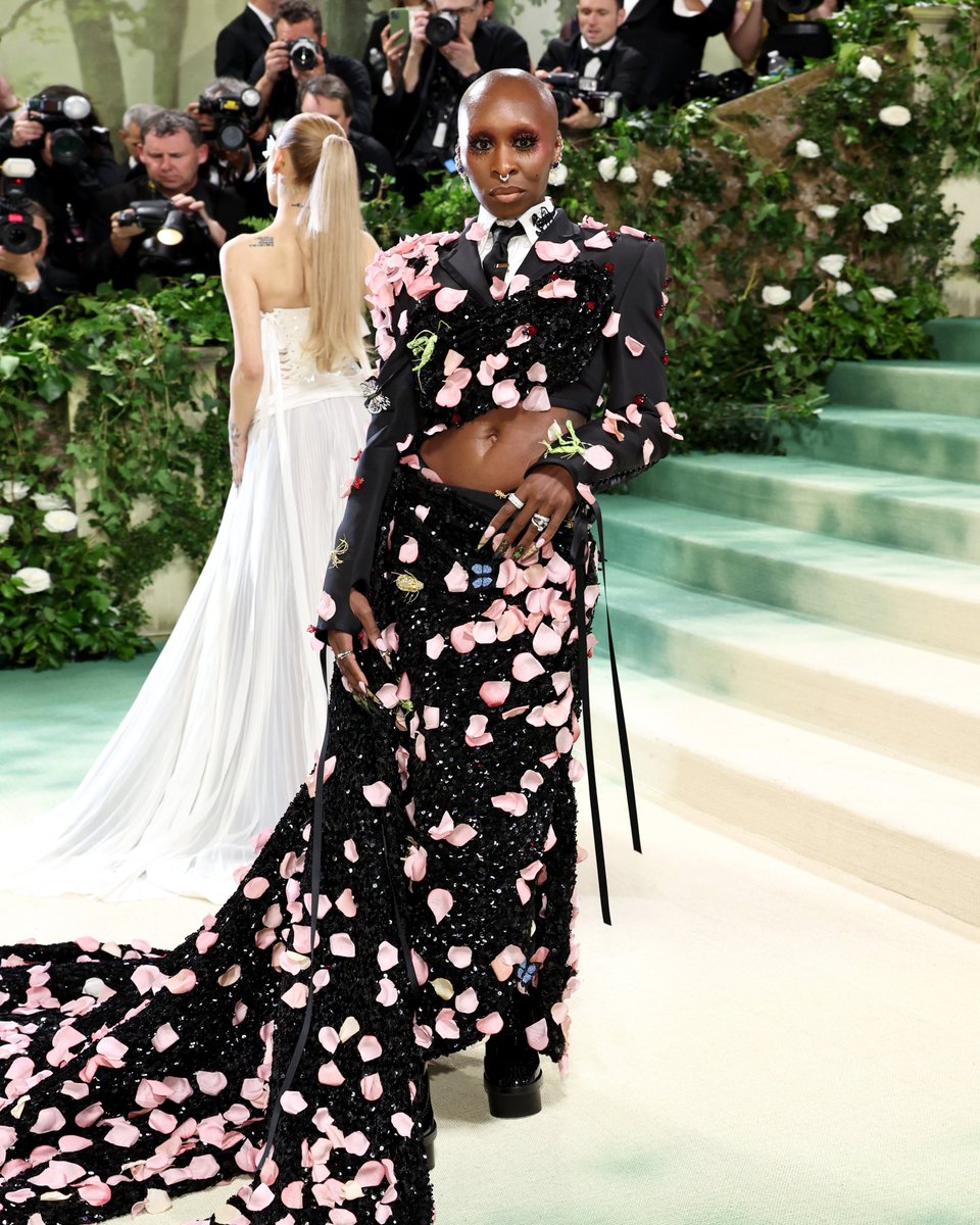 … cynthia … cynthia erivo wears a custom thom browne tailored jacket and skirt in black silk faille with silk satin lacing detail, shirt in white pique and black silk satin tie, all overlayed with black sequin and lurex embroidery and 2,000 individually sewn pink silk moire…