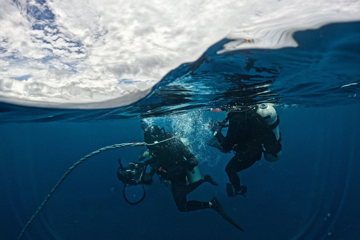 U.S. and Japanese troops unite in diving operations at Naval Base Guam, demonstrating seamless cooperation and operational interchangeability.