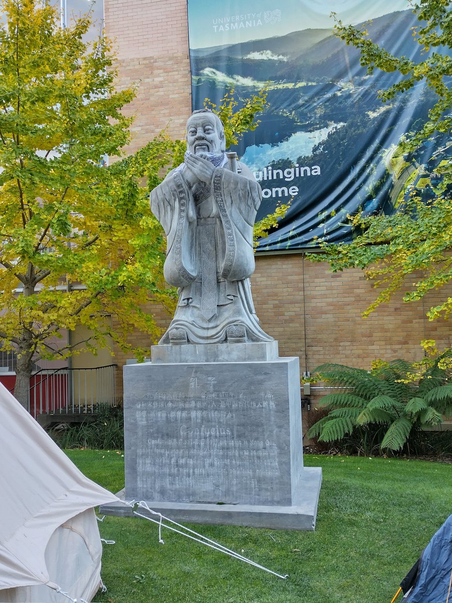 The concrete statue of 'Confucius' donated years ago to promote mutual understanding between China and Tasmania and situated outside the University of Tasmania library has been adorned with a keffiyeh as part of a Gaza student protest encampment.