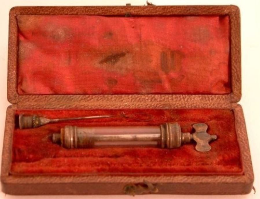 A glass and brass syringe in a velvet lined case. This syringe was owned by Alexander Wood who is credited with the invention of the hypodermic needle.