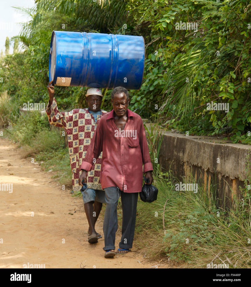 An image of an elite leaving the oil conference with his worker carrying a barrel of crude oil.